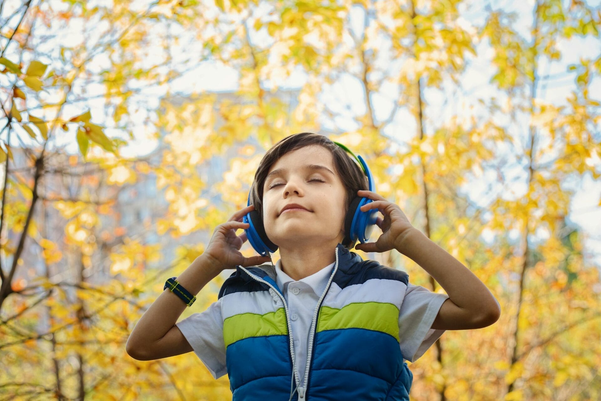 Photo of a Boy Listening in Headphones